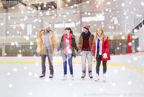 Image of happy friends on skating rink