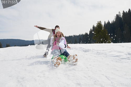 Image of happy young couple having fun on fresh show on winter vacation