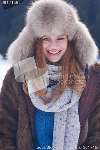 Image of portrait of beautiful young redhair woman in snow scenery