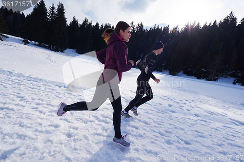 Image of couple jogging outside on snow