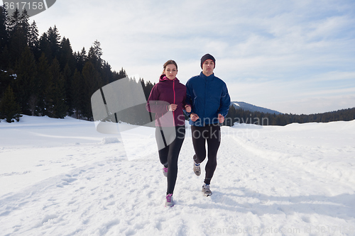 Image of couple jogging outside on snow