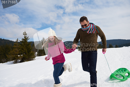 Image of happy young couple having fun on fresh show on winter vacation