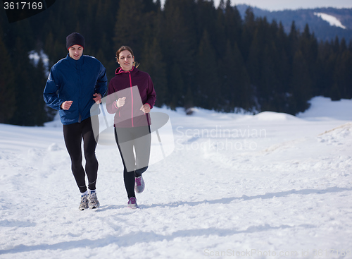 Image of couple jogging outside on snow