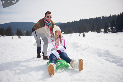 Image of happy young couple having fun on fresh show on winter vacation