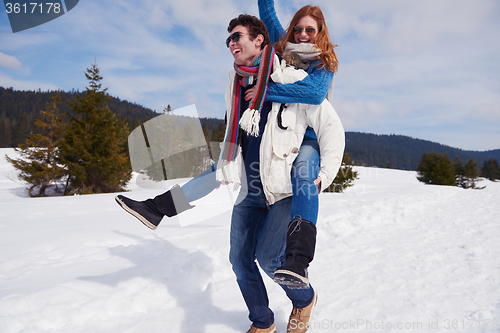 Image of happy young couple having fun on fresh show on winter vacation