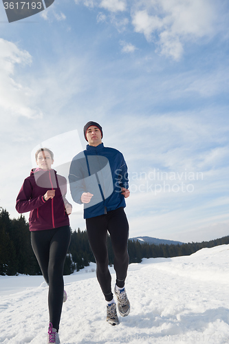 Image of couple jogging outside on snow