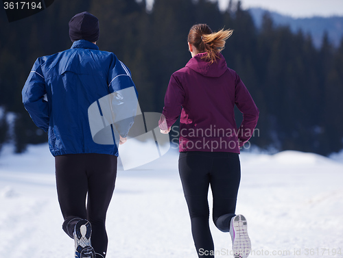 Image of couple jogging outside on snow