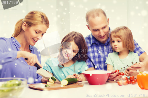 Image of happy family with two kids making dinner at home