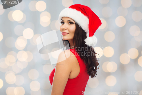 Image of beautiful sexy woman in santa hat and red dress