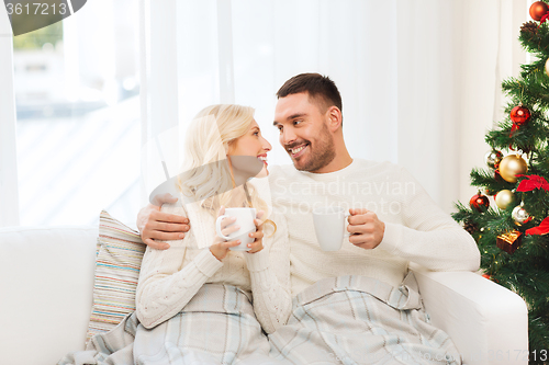 Image of happy couple at home with christmas tree