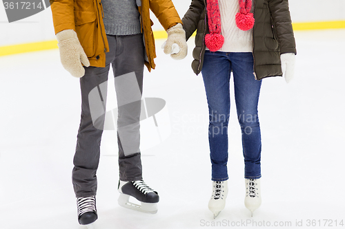 Image of close up of happy couple skating on ice rink