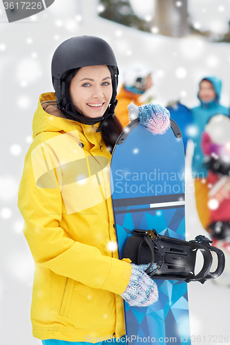 Image of happy friends in helmets with snowboards
