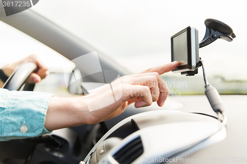 Image of close up of man with gps navigator driving car