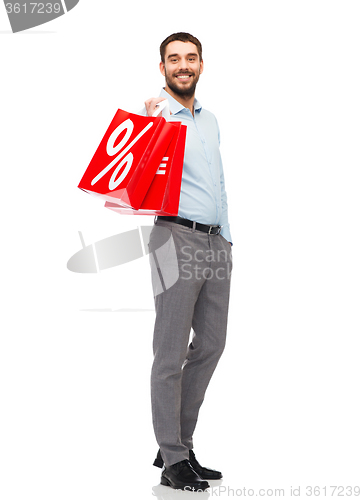 Image of smiling man with red shopping bag