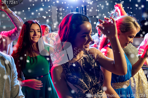 Image of smiling friends dancing in club