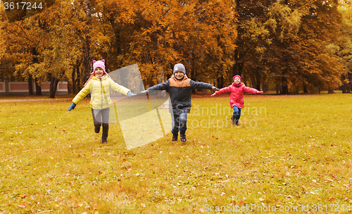 Image of happy little children running and playing outdoors