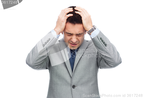 Image of businessman in suit having head ache