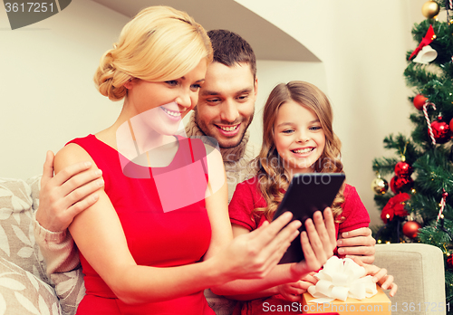 Image of smiling family with tablet pc