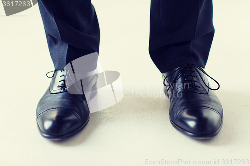 Image of close up of man legs in elegant shoes with laces