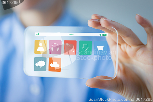 Image of close up of woman with transparent smartphone