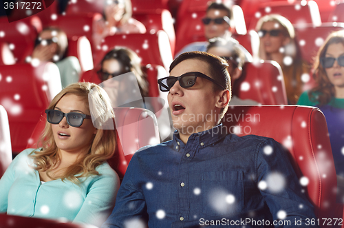Image of scared friends watching horror movie in 3d theater