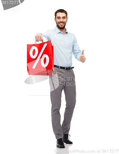 Image of smiling man with red shopping bag