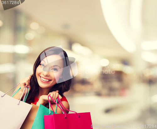 Image of smiling young woman with shopping bags