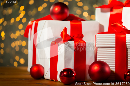 Image of gift boxes and red balls on wooden floor