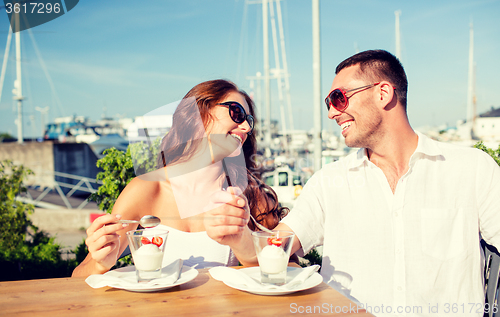 Image of smiling couple eating dessert at cafe