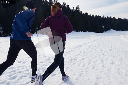 Image of couple jogging outside on snow