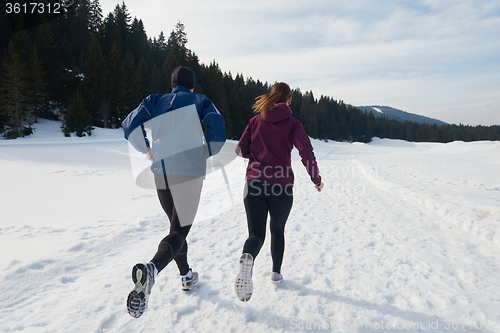 Image of couple jogging outside on snow