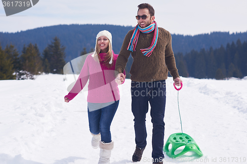 Image of happy young couple having fun on fresh show on winter vacation