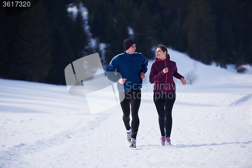 Image of couple jogging outside on snow