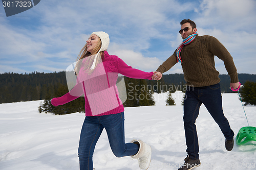 Image of happy young couple having fun on fresh show on winter vacation