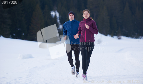 Image of couple jogging outside on snow