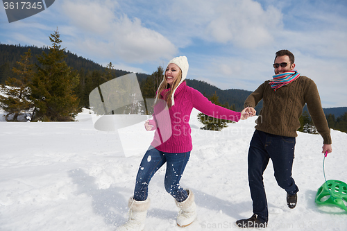 Image of happy young couple having fun on fresh show on winter vacation