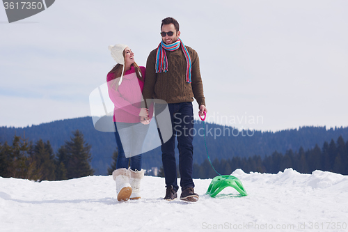 Image of happy young couple having fun on fresh show on winter vacation