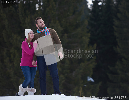 Image of couple having fun and walking in snow shoes