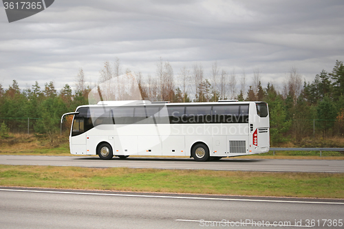 Image of White Coach Bus on Motorway on a Cloudy Day