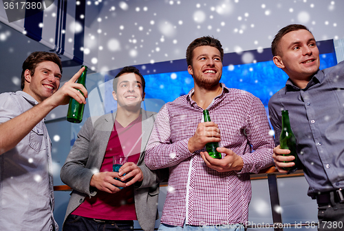 Image of group of male friends with beer in nightclub