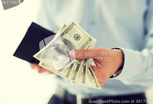 Image of close up of businessman hands holding money