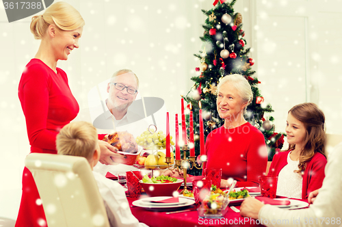 Image of smiling family having holiday dinner at home