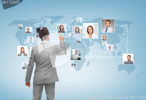 Image of businessman pointing finger to contact icons