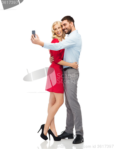 Image of happy couple taking selfie with smartphone