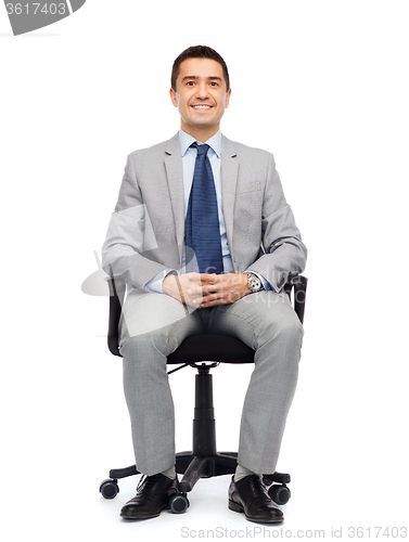 Image of happy businessman  sitting in office chair