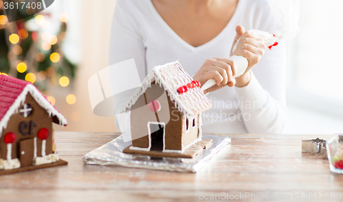 Image of close up of woman making gingerbread houses