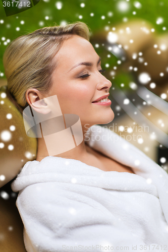 Image of close up of woman sitting in bath robe at spa