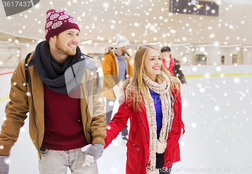 Image of happy friends on skating rink