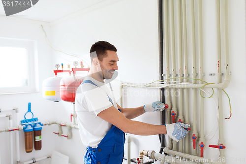 Image of builder or plumber working indoors