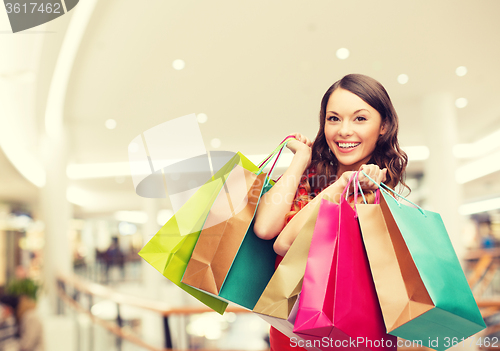 Image of smiling young woman with shopping bags